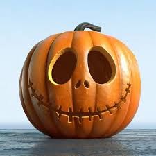 a carved pumpkin sitting on top of a cement floor next to the ocean and sky