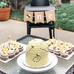 a table topped with cupcakes covered in frosting