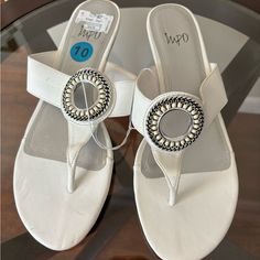 White Impo Sandals Never Worn Low Wedge Heel Silver Embellishments Slight Pen Mark But Barely Noticeable. Can Probably Be Rubbed Off With Soap Elegant Adjustable Wedge Sandals For Vacation, Elegant White Wedge Sandals For Summer, White Low-top Sandals With Removable Insole, White Slip-on Footbed Sandals With Removable Insole, White Adjustable Non-slip Sandals, White T-strap Sandals With Removable Insole For Summer, White Non-slip Flip Flops For The Beach, Low Heel Wedges, Dressy Sandals