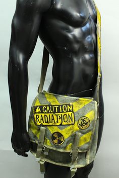 Post Apocalyptic Bag - Radiation Ammo Pouch - Military Canvas Pack - Messenger Bag - Biohazard - Patches - Larp Accessory - Yellow Stripes This listing is for a made to order bag. Please Note: The pack pictured above is representative of the style. Individual purse will vary in appearance. Simple military bag with post-apocalyptic decorations. Hand-painted stripes on the canvas and lettering + a bomb on leather patches sewn on the closure. The last photo is here to show an additional strap optio Apocalyptic Fashion, Military Bag, Estilo Punk, Swaggy Outfits, Character Outfits, Refashion Clothes, Post Apocalyptic, Yellow Stripes, Larp