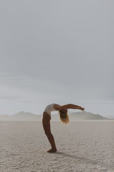 a woman doing a handstand in the desert