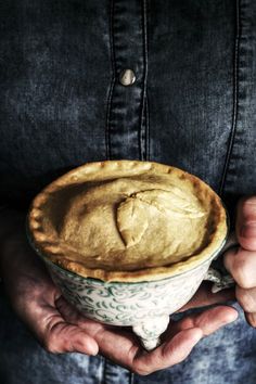 a person holding a pie in their hands