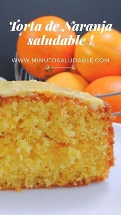 a piece of cake sitting on top of a white plate next to some oranges