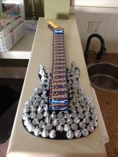 a very tall tower made out of candy bar wrappers on top of a counter