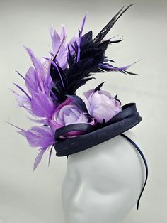 Navy blue hat accented with beautiful lavender feathers and flowers. Style to go with a variety of outfits: bridesmaids,  cocktail party,  Kentucky Derby, Rehearsal dinner, Easter and church outfits.  Ones with hair clip and headband. Are you trying to match an outfit? Send a picture and I will help you find a best hat to match your outfit.  - Rare find - Ready to ship  - Lightweight - Free Shipping - Fast shipping - Customize by adding different color flowers and or feathers Check my store for for styles and colors.  Hatsandpearls.etsy.com Find more at my website: www.hatsandpearls.com Reach out to me if you can't find what you are looking for.  I can make cake custom orders and help you style and match your outfit  Thank you for visiting! Purple Feather Headpieces For Spring, Purple Feathered Headpieces, Formal Mini Hats With Feather Trim For Royal Ascot, Purple Feathered Headpieces For Kentucky Derby, Purple Mini Hats With Feathers For Kentucky Derby, Purple Feathered Hat For Kentucky Derby, Purple Feathered Mini Hats For Kentucky Derby, Purple Headpiece With Handmade Flowers For Kentucky Derby, Purple Handmade Flowers Headpiece For Kentucky Derby