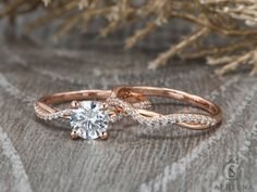 an engagement ring with a diamond in the center on top of a cloth covered surface