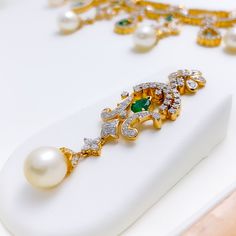 PRODUCT DETAILS Gold Purity(karat): 18k Item Weight(grams): 73.8 Item Finish: Yellow Gold Stone: Diamond Diamond Weight(carats): 9.27 ct Pearl weight (carats): 42.14 Emerald weight (carats): 3.14 Diamond Color: F-G Diamond Quality: VS Set Length: 15" Drop Length: 1.8" Lock Style: Hook Lock Adjustable Links: 2.1" Matching Earrings: Included Earring Length: 2.1" Earring Post: ﻿Screw Back Elegant Yellow Gold Hand Set Emerald Necklace, Luxury Gold Emerald Diamond Necklace, Luxury Diamond Necklace With Emerald In Gold Setting, Elegant 22k Gold Emerald Necklace For Celebration, Gold Emerald Jewelry Sets For Formal Occasions, Luxury Yellow Gold Emerald Necklace For Wedding, Gold Emerald Jewelry Sets For Formal Events, Elegant Green Emerald Necklace In 22k Gold, Elegant Yellow Gold Emerald Necklace For Festive Occasions