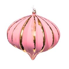 a pink and gold ornament hanging on a white wall in the shape of a ball