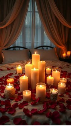 a bunch of lit candles sitting on top of a bed with rose petals around it