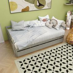 a bedroom with green walls and white bedding, rugs on the wooden floor