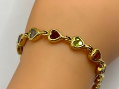 "Welcome to Gold Knox  Beautiful 18k yellow gold heart bezel multi color stone bracelet. The bracelet features 12 heart shaped cut multi color gemstones in bezel setting. Great piece and gift idea for any special occasion.  Details below: Material    18k gold,  Weight       17.8 gm Length        7\" Hallmark    18k SHIPS SAME DAY PLEASE, BE SURE TO VIEW THE PICTURES CAREFULLY AND CLOSELY AS IT IS THE EXACT ITEM YOU ARE BUYING.  Gold Knox Jewelry  opened its storefront in Pasadena, CA in 2011, since then we do our BEST to serve our communities. A few years later we opened our online shop and joined Etsy  where we offer our unique and desirable pieces for everyone. Most of our items are vintage and they are previously used, however we inspect and clean each of them before selling. We stand b Jewelry Lookbook, Maximalist Jewelry, Star Bracelet, Bezel Bracelet, Sirius Black, Buying Gold, Elegant Pendant, Wedding Jewelry Bracelets, Heart Gemstone