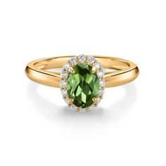 an oval green tourmaline and diamond ring in yellow gold with diamonds around the band