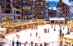 people skating on an ice rink in the middle of town