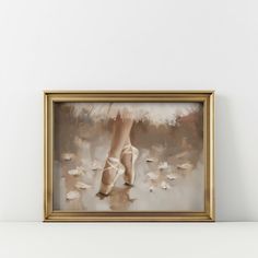 an oil painting of a ballerina's feet in white and gold framed on the wall