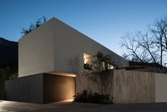 an exterior view of a modern house at dusk