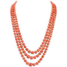 This elegant Vintage necklace incorporates three strands of graduated barrel-shaped natural red color coral beads measuring from 11mm to mm in diameter. The coral beads are silk-strung and inserted throughout the three strands by enchanting 18K yellow gold beads of identical barrel shape. This authentic vintage necklace secures with a finely textured orbicular yellow gold clasp and remains in excellent condition. Weight: 128.7 grams Measurements: Coral strands 22.5 , 24 and 27 inches long Coral Gold Beads Necklace, Beading Necklaces, Necklaces Red, Necklaces Beaded, Amber Bead Necklace, Necklaces Vintage, Red Coral Necklace, Coral Beads Necklace, Graduation Necklace