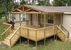 a mobile home is shown with steps leading up to the porch and covered in wood