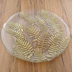 a glass plate with gold leaves on it