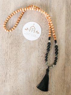 Boho style beaded necklace with large tassel in black Black 8mm Beads Beach Jewelry, Black Beach Jewelry With 8mm Beads, Black Beaded Jewelry For Beach, 8mm Beads, Black Wooden Beads For Beach, Black Wooden Beads Necklace For Beach, Black Bohemian Necklace For Beach, Bohemian Black Necklace For Beach, Black Spiritual Necklace For Beach, Bohemian Black Onyx Beaded Necklace