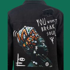 Unleash the power of self-expression with the Radiant Soul Denim Jacket, exclusively from La Luz Boutique. This isn’t just any denim jacket; it’s a statement of strength and beauty. The bold graphic on the back depicts a majestic profile adorned with an intricately patterned headwrap, alongside the empowering phrase “You Won’t Break My Soul”. Distressed detailing adds an edgy touch to the classic silhouette, making it the perfect layer for those who carry their spirit on their sleeve. • Style: O Trendy Graphic Print Denim Jacket For Streetwear, Urban Graphic Print Denim Jacket For Winter, Urban Denim Jacket With Graphic Print For Winter, Urban Style Winter Denim Jacket With Graphic Print, Punk Denim Jacket With Graphic Print, Punk Style Denim Jacket With Graphic Print, Punk Style Graphic Print Denim Jacket For Streetwear, Punk Denim Outerwear With Graphic Print, Black Denim Jacket With Graphic Print