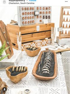 an assortment of items displayed on a table in front of a wooden box filled with sand