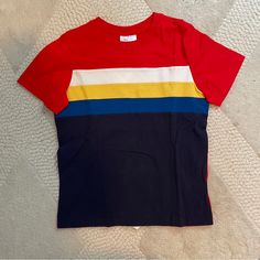 Nwt Hanna Andersson T-Shirt In Red And Navy Blue With White, Yellow And Royal Blue Stripes. Soft Cotton, Perfect For Beach, Camp, Summer Vacation. Size 120 Which Equates To 6-7. Would Work For Boys Or Girls. Bundle With Other Hannas In My Closet To Save On Shipping! Smoke- And Pet-Free. Make An Offer! Short Sleeve Cotton Color Block Shirt, Short Sleeve Color Block Cotton Shirt, Sporty Striped Color Block Top, Graphic Tee Color Block Cotton T-shirt, Color Block Graphic Tee Cotton T-shirt, Color Block Cotton Graphic Tee, Cotton Color Block Graphic Tee, Red Cotton Color Block T-shirt, Striped Color Block Cotton Tops