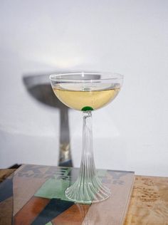 a wine glass sitting on top of a wooden table