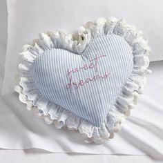 a heart shaped pillow on top of a bed with the words happy birthday written on it