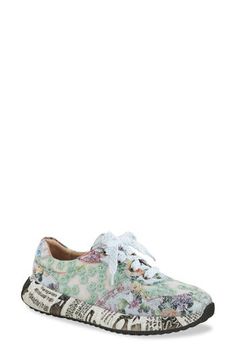 A flowery design makes sure you stand out in a hand-painted sneaker grounded by a sporty sole covered in a newspaper print. This statement-making kick is fitted with a cushy, arch-supporting footbed for endless comfort. 1 1/2" heel Cushioned footbed with arch support Synthetic upper/textile lining/rubber sole Imported Multicolor Floral Print Slip-on Sneakers, Sporty Floral Print Sneakers With Round Toe, Floral Print Round Toe Sneakers For Spring, Spring Floral Print Sneakers With Round Toe, Green Low-top Sneakers With Graphic Print, Casual Sneakers With Graphic Print For Spring, Spring Floral Print Round Toe Sneakers, High-top Floral Print Sneakers For Spring, Sporty Floral Print Sneakers For Streetwear