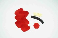 red felt pieces are laid out on a white surface