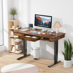 a wooden desk with a computer monitor and keyboard on it in front of a window