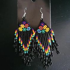 These handmade, bohemian vintage braided beaded tassel earrings are perfect for adding a unique touch to any outfit. Made from high-quality beads and durable copper ear needles for a comfortable fit. Designed in a vintage, boho style, suitable for daily wear and festival celebrations, including Mardi Gras. Every pair is handcrafted, making each one one-of-a-kind with slight variations. Multicolor Jewelry With Black Beads For Summer, Summer Multicolor Jewelry With Black Beads, Adjustable Bohemian Beaded Earrings With Black Beads, Bohemian Multicolor Beaded Earrings With Black Beads, Traditional Multicolor Dangle Tassel Earrings, Multicolor Dangle Jewelry With Black Beads, Bohemian Adjustable Beaded Earrings, Adjustable Handwoven Dangle Tassel Earrings, Handmade Multicolor Tassel Drop Earrings