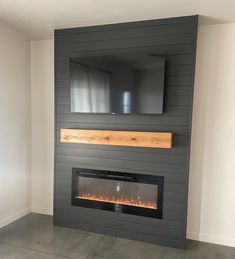 a fireplace with a tv mounted on the wall