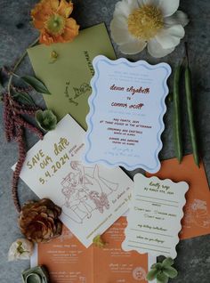 the wedding stationery is laid out on the ground