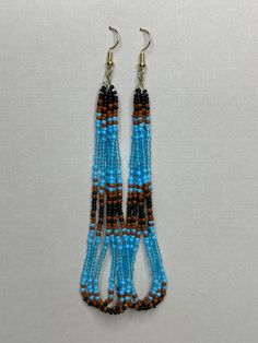 Made of glass seed beads and strong nylon B thread string, this pair is hung on sterling silver posts. Adjustable Long Drop Beaded Earrings With Dangling Beads, Gift Heishi Bead Earrings With Round Beads, Round Beaded Heishi Bead Earrings As Gift, Long Drop Beaded Earrings, Adjustable Long Drop Beaded Earrings With Colorful Beads, Colorful Long Drop Beaded Earrings With Adjustable Fit, Adjustable Hand-strung Beaded Earrings As Gift, Adjustable Turquoise Beaded Earrings With Large Beads, Heishi Beads Jewelry With Dangling Beads As Gift