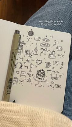 a notebook with drawings on it and a pen in front of the page that says i love you