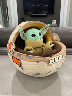 a baby yoda doll sitting in a star wars themed basket with the force awake on it