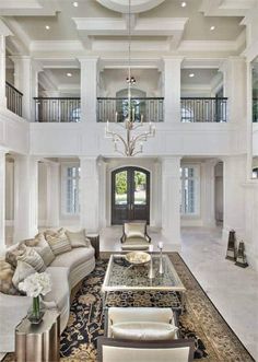 a large living room with high ceilings and chandelier