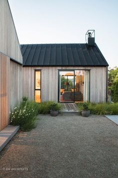 a house that has some plants in front of it