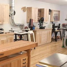 a kitchen with lots of wood cabinets and tools on the counter top in front of it