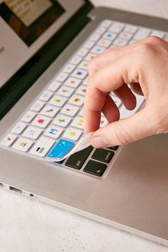 a person using a keyboard on a laptop computer