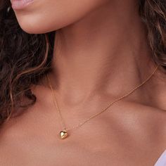 Hearts are the ultimate symbol of love. Show off your affectionate side with our Puffed Heart Necklace, featuring a rounded, puffy heart at the center of a classic chain. A wonderful gift for special occassions, this pendant necklace is a must-have you will be reaching for every day. - Gold plated over brass- Heart is approx. 0.8cm across- Adjustable length measures 16"-18"- Available in Yellow Gold only Everyday Heart Locket Necklace For Valentine's, Heart-shaped Locket Necklace For Valentine's Day, Classic Heart Pendant Necklace With Adjustable Chain, Classic Heart Shaped Pendant Necklace For Valentine's Day, Oval Pendant Necklace For Valentine's Day Anniversary, Oval Pendant Necklace For Anniversary On Valentine's Day, Valentine's Day Oval Pendant Necklace For Anniversary, Classic Heart Pendant Charm Necklace For Valentine's Day, Puffed Heart Necklace