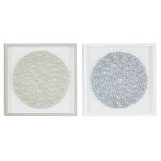 two framed artwork pieces, one white and the other gray with circles in them on a white background