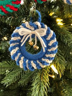 a blue and white ornament hanging from a christmas tree