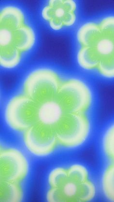 an abstract image of green and white flowers on a blue background with light from the center