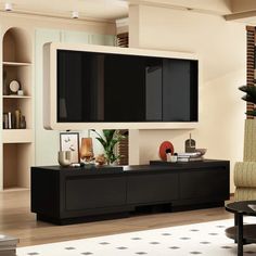 a living room with a large flat screen tv mounted on the side of it's wall