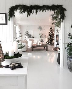 a white room with candles and christmas decorations