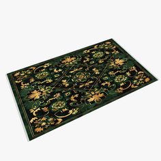 a green rug with gold flowers and leaves on the bottom, in front of a white background