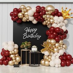 a birthday party backdrop with balloons and streamers in red, gold and white colors