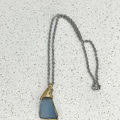 Elevate your style with our Men's Sterling Silver Sea Glass Necklace, a symbol of timeless elegance and coastal allure. This necklace features a stunning sterling silver pendant adorned with authentic, ocean-tumbled blue sea glass. The rugged yet refined design captures the essence of the sea, making it a perfect accessory for any man who appreciates both sophistication and nature's beauty. Embrace the power of the ocean with this unique and masculine necklace. 🌊💎⚓ Sterling Silver Sea Glass Pe Everyday Silver Glass Jewelry, Blue Stainless Steel Necklace Ideal For Gift, Blue Stainless Steel Necklace For Gift, Blue Nickel-free Stainless Steel Jewelry, Blue Stainless Steel Chain Jewelry, Blue Stainless Steel Nickel-free Jewelry, Blue Stainless Steel Necklace With Adjustable Chain, Elegant Blue Sea Glass Jewelry, Wire Wrapped Silver Necklace With Sea Glass